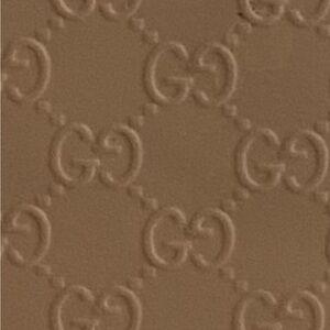 Gucci Microguccissima patent leather tote bag in a neutral pink or beige shade.